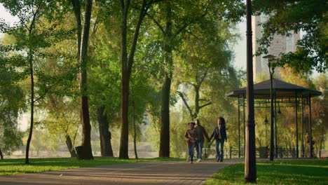 child running park path enjoying family evening outdoors. caring people together