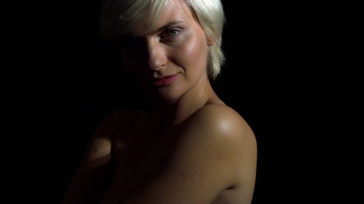 A naked woman expressing confidence as the photographer zoom in to capture her gorgeous smile