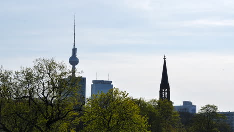 view of berlin skyline, church tower next to fernsehturm tv tower