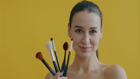 woman holding makeup brushes