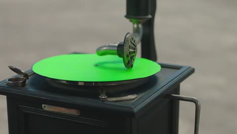 vintage gramophone . vintage old gramophone plays a vinyl record on green screen background . wooden case turntable . vinyl phonograph . shot on arri alexa cinema camera in slow motion .