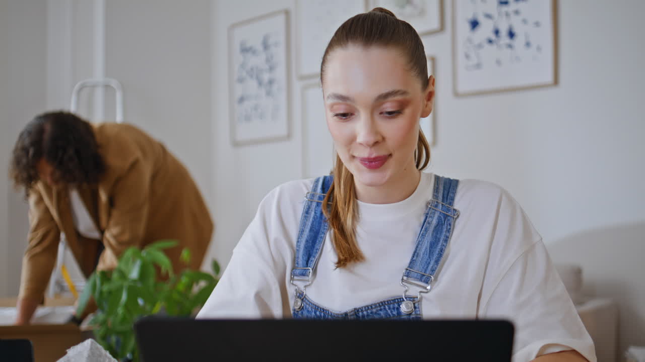 Smiling woman chatting laptop in contemporary living room closeup. Happy lady