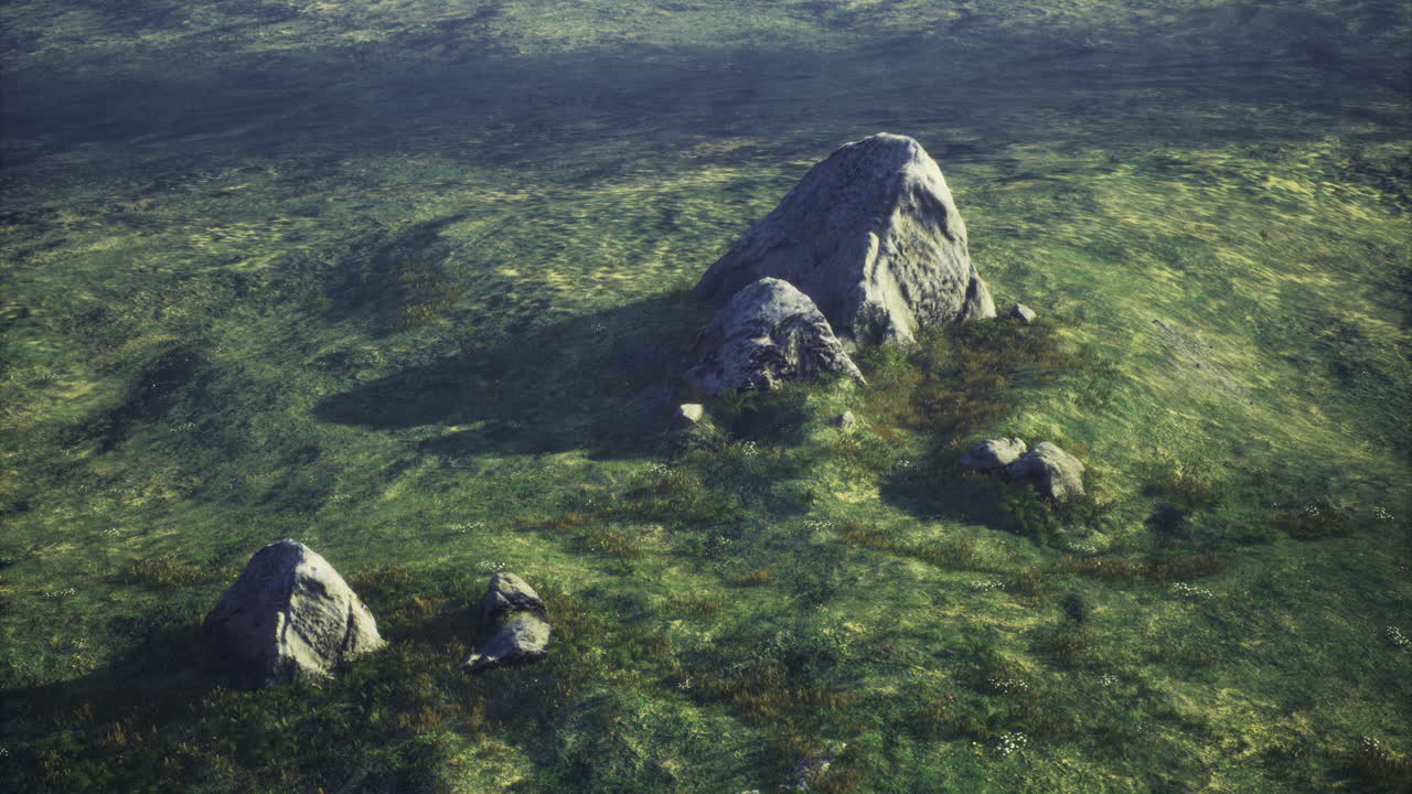 Unique rock formations in a serene grassy landscape under soft light