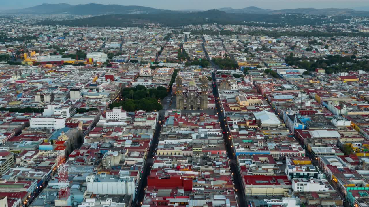 Cinematic Aerial Hyperlapse Toward Mexican Puebla Cathedral with Tilt Down Spin Reversing to Pull Back at Sunset