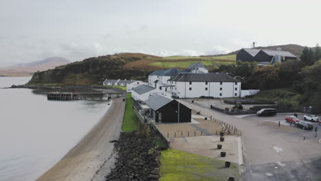 whisky distillery aerial bunnahabhain over distillery welcome sign