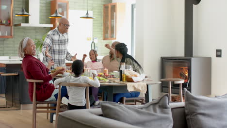 African-american-parents,-children-and-grandparents-celebrating-at-thanksgiving-dinner,-slow-motion