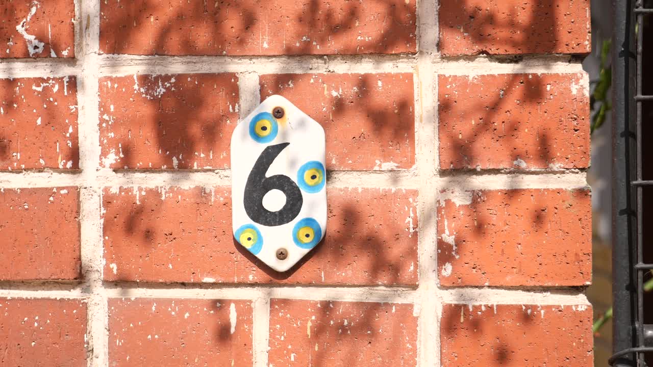 House Number 6 on a Brick Wall