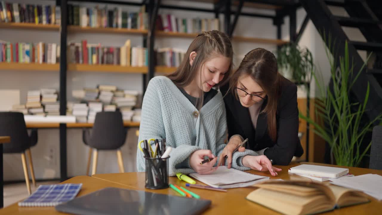 Student and Teacher Studying Together in a Library