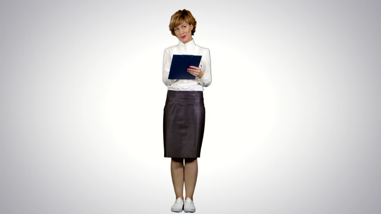 Portrait of young businesswoman with tablet asking questions on white background