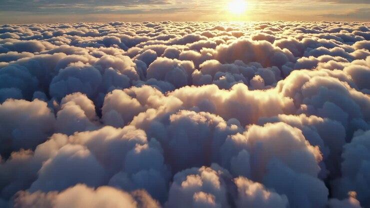Sunrise or Sunset Above Fluffy Clouds