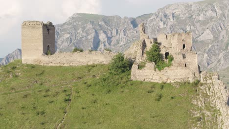 cinematic drone shot slowly ascending to reveal the medieval trascău fortress ruins in colțești, romania. an epic historical landmark in the mountains of transylvania