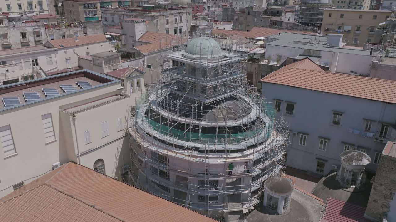 Slow aerial footage rotating towards the under construction dome of Chiesa di San Vincenzo de' Paoli in Naples, Italy.