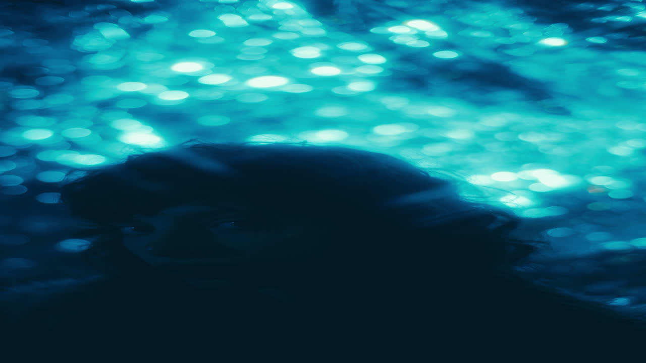 Portrait of Attractive Woman with Glitter on Face Posing among Blurred Lights