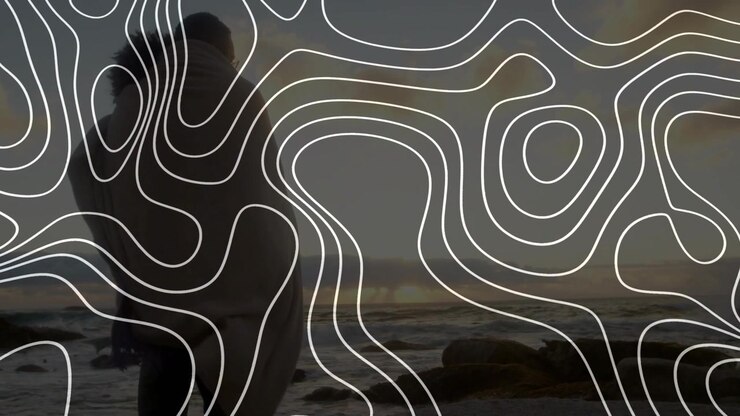 Man wrapping shawl around partner carrying to sea while contour overlay framing silhouette for ads