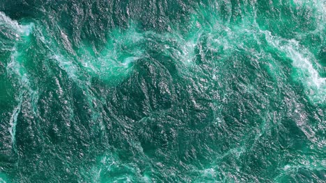 blue waves of water of the river and the sea meet each other during high tide and low tide.