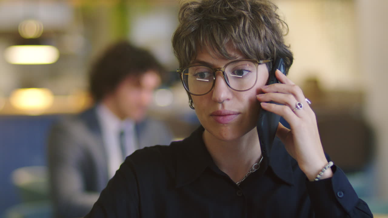 Young Businesswoman Talking on Mobile Phone at Restaurant