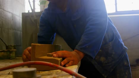 mid section of worker making mold at table in workshop 4k