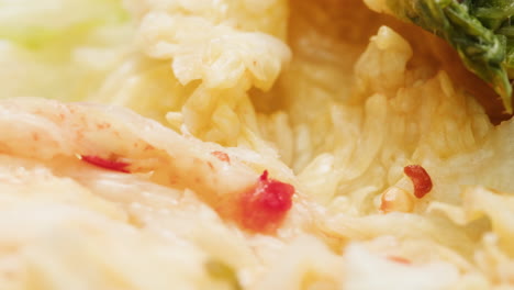 close-up of texture fermented spicy cabbage kimchi with in can. preservation of vegetables in glass jars. fermentation preserved kimchi cabbage with spices macro. asian cuisine. high quality 4k footage