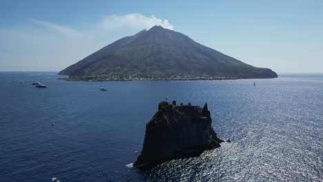 active volcano stromboli and strombolicchio at aeolian islands, italy - aerial 4k