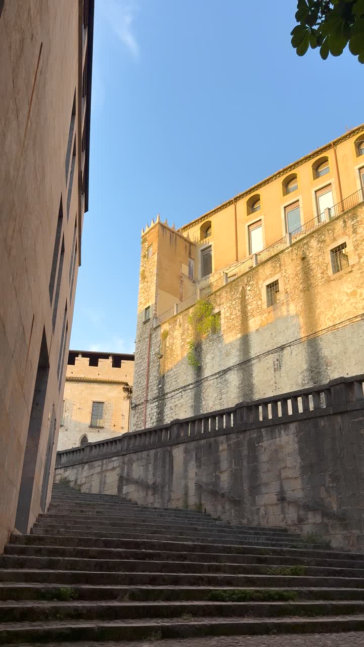 Medieval Girona architecture under blue sky evokes history and tranquility