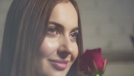 attractive woman receives a rose and her face is delighted