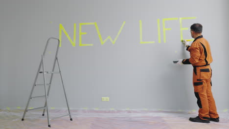 renovation project: painting a wall with the words 'new life'