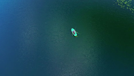 aerial view of person in the boat fishing in the lake