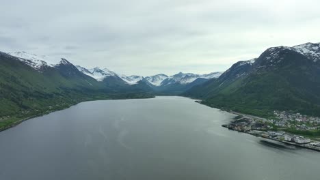 Isfjorden-fjord-beside-Andalsnes-in-Rauma-Norway---Aerial-above-fjord-with-stunning-mountain-scenery-in-background