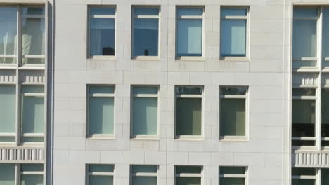 Aerial-view-in-front-of-windows-of-a-tall-apartment-building-in-sunny-New-York