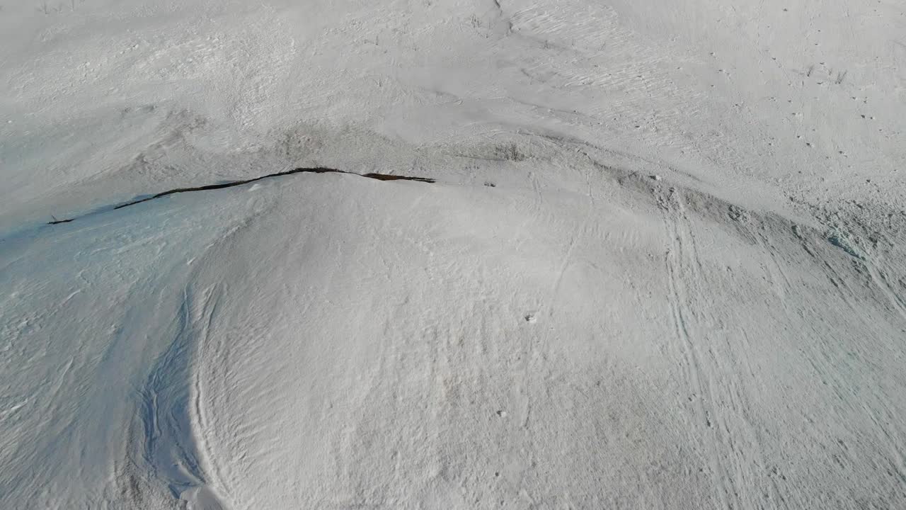 Looking over snowy mountain cliff