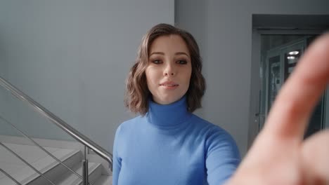 young woman uses an interactive scoreboard in the office's lobby, woman inserts the pincode on the cash machine, usage of the atm at public place, 4k prores hq