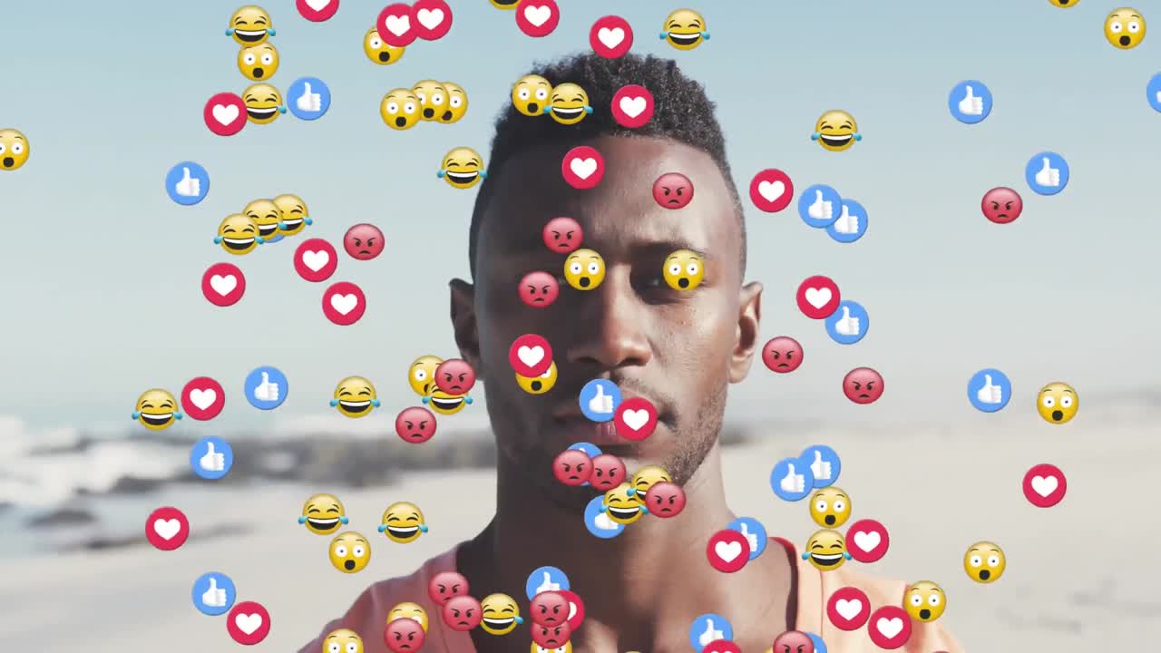Multiple digital icons floating against portrait of african american man smiling on the beach