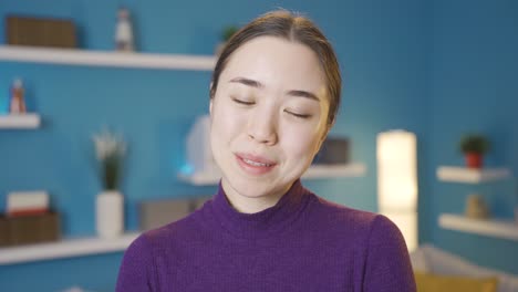 cute asian woman smiling at camera approaching her.