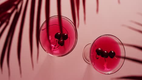 Close-up-of-drinks-with-cherries-on-white-background