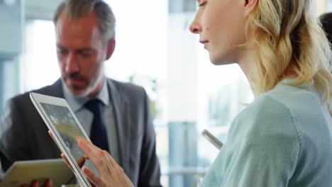 woman and businessmen using digital tablet