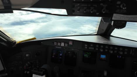 a jet cockpit scene during a real time flight over the clouds