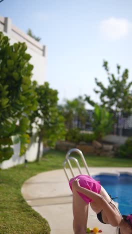 woman doing yoga by the pool