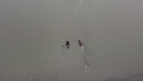 wooden fishing boat leaving the shore of kuakata in bangladesh