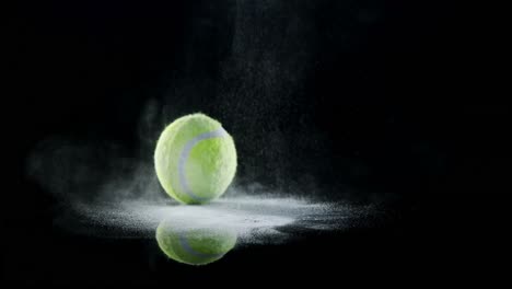 bouncing ball with powder against black background