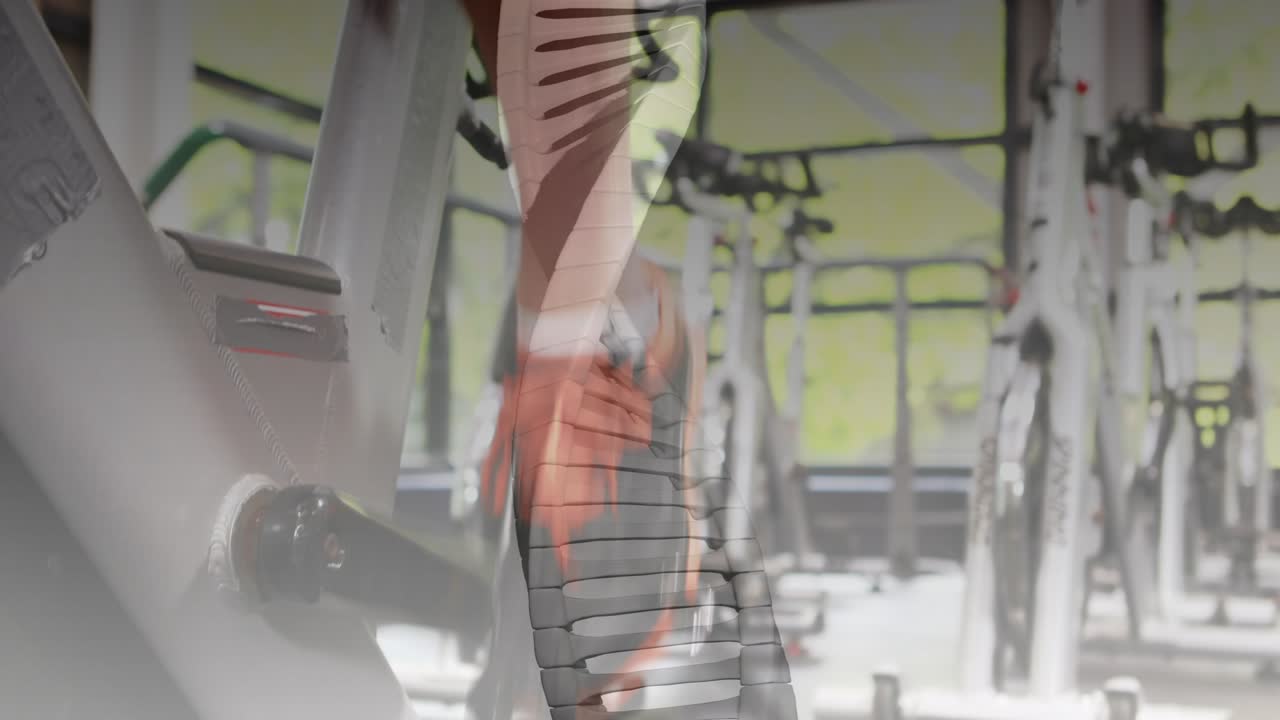 Man adjusting resistance knob and pedaling on spin bike, DNA helix overlay tracking cardio progress