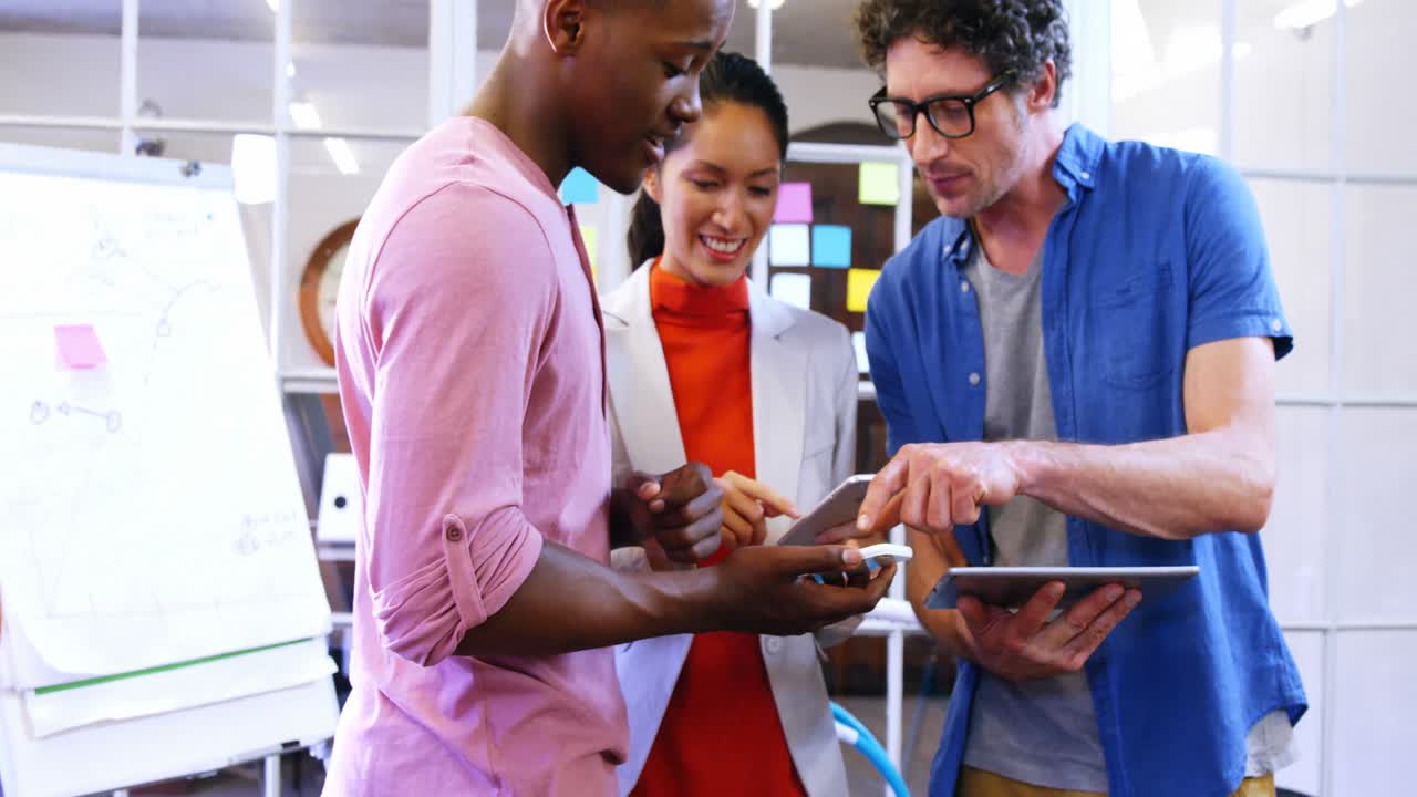 Business executives using mobile phone and digital tablet