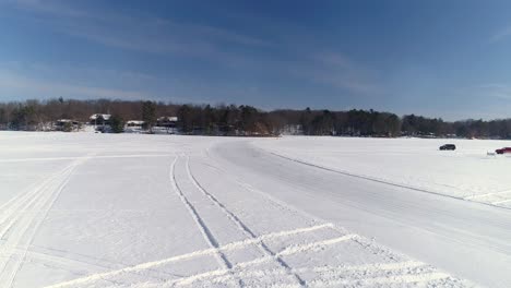 specially built utility vehicle races around a snow covered bend at a winter sport event