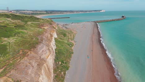 newhaven cliffs and beach with turquoise water on a sunny day, aerial view