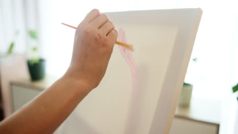 person painting on canvas