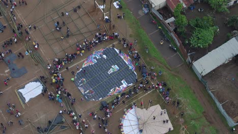 overhead view of big kite laying on the ground at sumpango kite festival, aerial