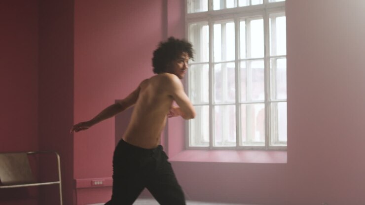 Young man dancing in a classroom