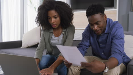 a young couple looking stressed out while doing