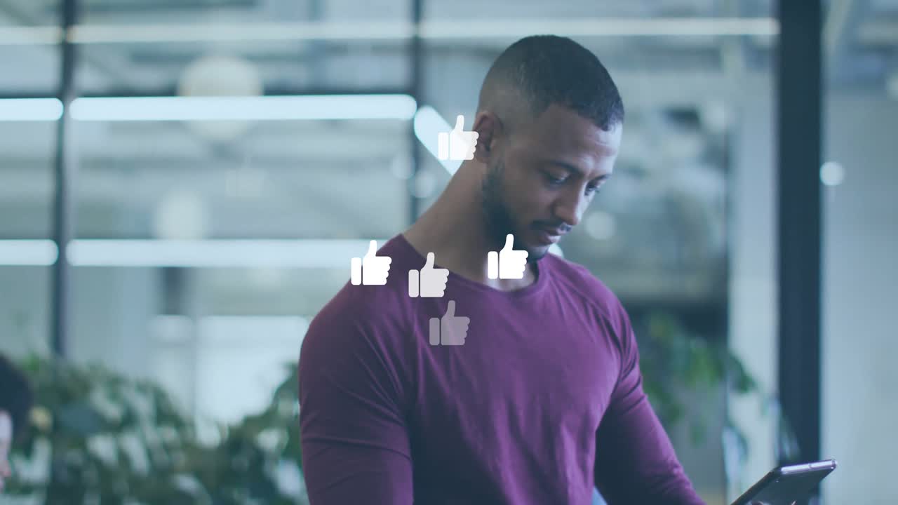 Office worker tapping tablet and seeing animated thumbs-up icons floating for social media feedback