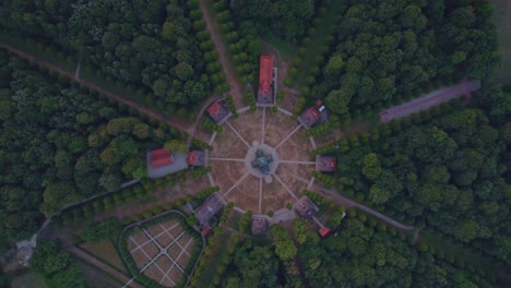 Top-down-view-of-Clemenswerth-Castle-Germany-during-sunrise,-aerial