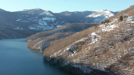 aerial view of a lake surrounded by the snow